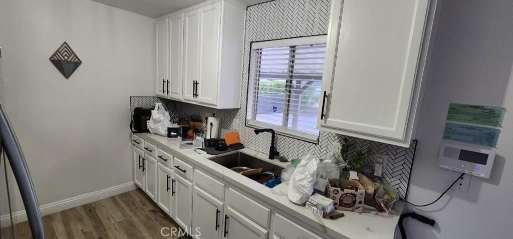 16125 Via Vis, Desert Hot Springs, CA 92240 - kitchen featuring white cabinetry, backsplash, and light countertops