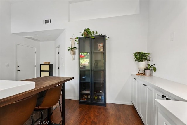 1046 Calle Del Cerro Unit 408, San Clemente, CA 92672 - bar featuring dark wood-style flooring and baseboards