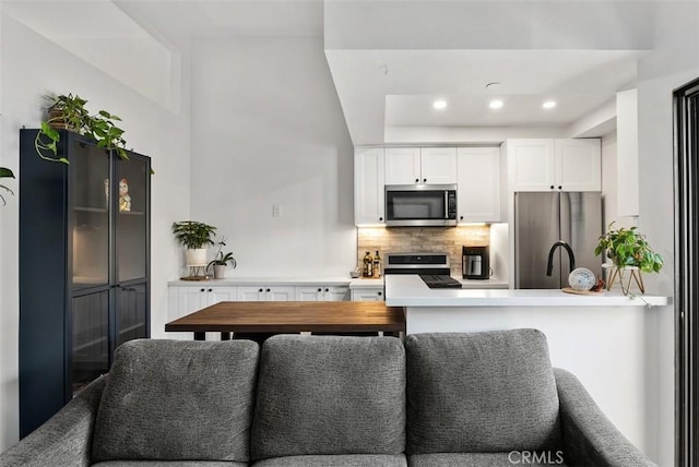 1046 Calle Del Cerro Unit 408, San Clemente, CA 92672 - kitchen featuring stainless steel appliances, decorative backsplash, white cabinetry, light countertops, and recessed lighting
