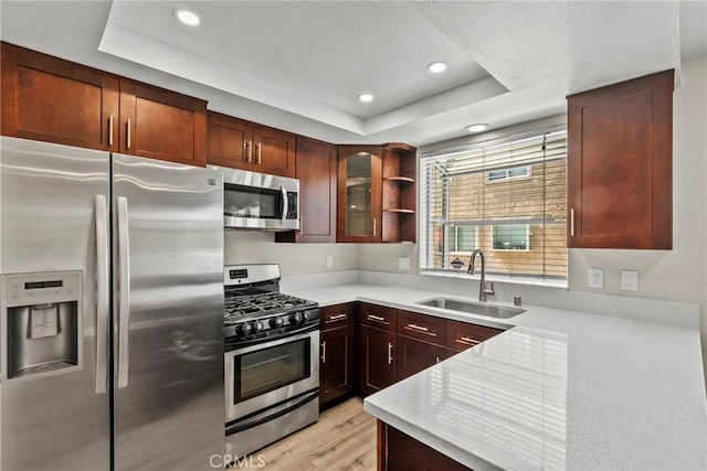 17910 River Cir Unit 5, Canyon Country, CA 91387 - kitchen with stainless steel appliances, a tray ceiling, light countertops, glass insert cabinets, and recessed lighting