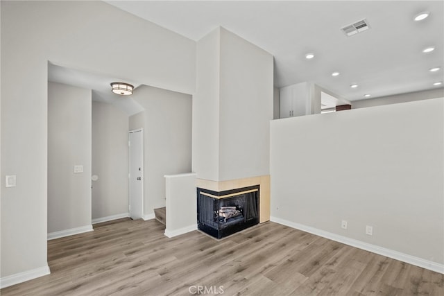 17910 River Cir Unit 5, Canyon Country, CA 91387 - unfurnished living room featuring wood finished floors, recessed lighting, and a multi sided fireplace