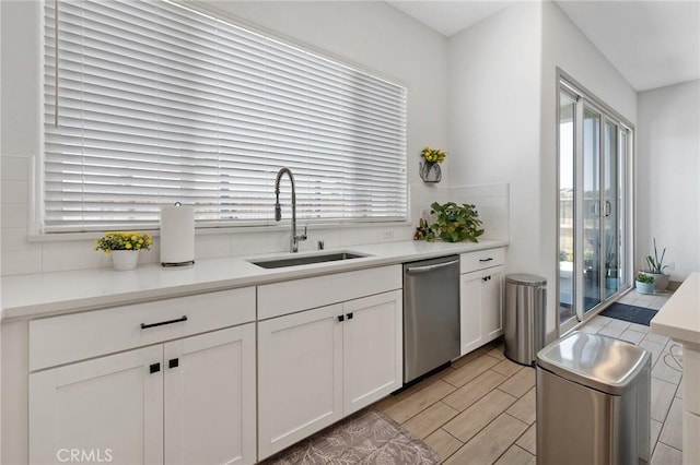 1938 N Frontier St, Hanford, CA 93230 - kitchen featuring stainless steel dishwasher, white cabinetry, light countertops, and wood finish floors