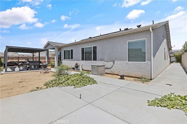 1938 N Frontier St, Hanford, CA 93230 - back of house with a patio area, a fenced backyard, and stucco siding