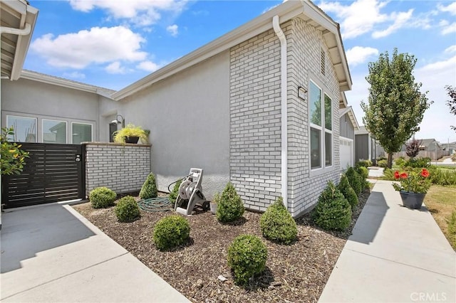 1938 N Frontier St, Hanford, CA 93230 - view of side of home featuring a gate and brick siding
