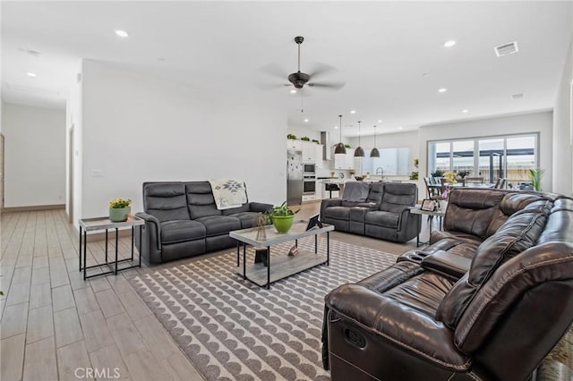 1938 N Frontier St, Hanford, CA 93230 - living area with ceiling fan, recessed lighting, and light wood-style floors