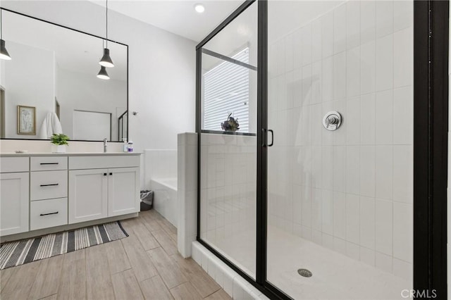 1938 N Frontier St, Hanford, CA 93230 - full bath with double vanity, a bath, a shower stall, and wood finished floors