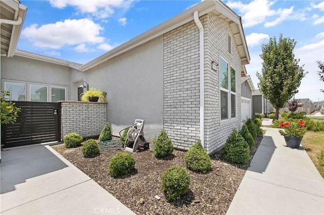 1938 N Frontier St, Hanford, CA 93230 - view of property exterior featuring a gate and brick siding