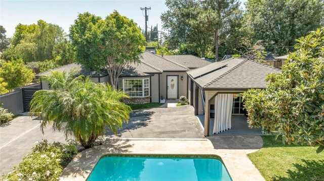 11063 White Oak Ave, Granada Hills, CA 91344 - rear view of property with solar panels, an outdoor pool, roof with shingles, and a patio
