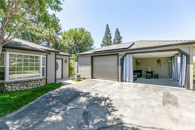 11063 White Oak Ave, Granada Hills, CA 91344 - view of front of home featuring solar panels, a detached garage, and driveway