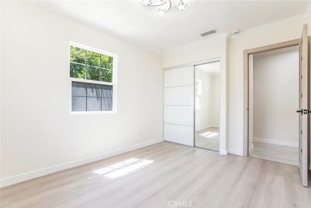11063 White Oak Ave, Granada Hills, CA 91344 - unfurnished bedroom featuring ornamental molding, multiple windows, a closet, and light wood-style floors
