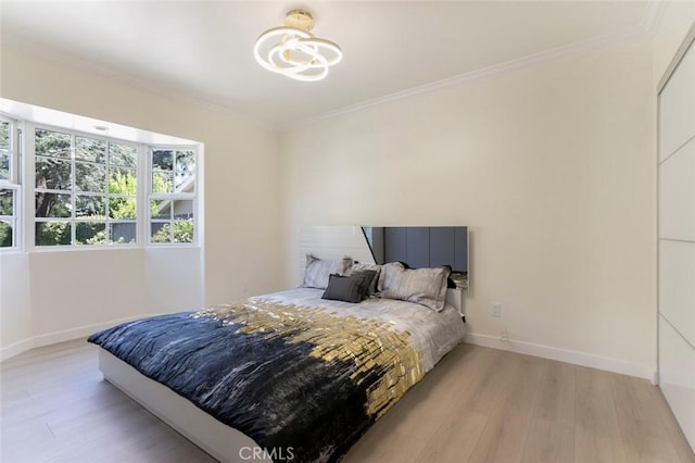 11063 White Oak Ave, Granada Hills, CA 91344 - bedroom with light wood-type flooring, ornamental molding, and a chandelier