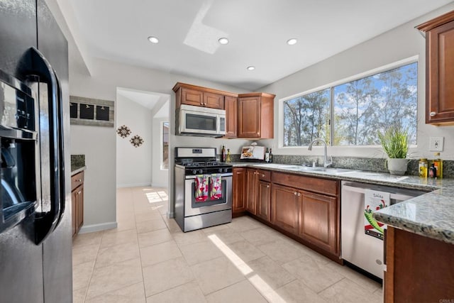 1161 Senwood Way, Fallbrook, CA 92028 - kitchen with appliances with stainless steel finishes, light stone countertops, recessed lighting, brown cabinets, and light tile patterned floors