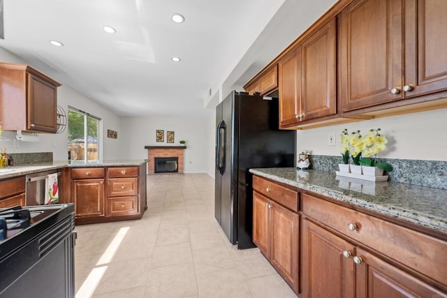1161 Senwood Way, Fallbrook, CA 92028 - kitchen with black appliances, a brick fireplace, brown cabinetry, light stone counters, and recessed lighting