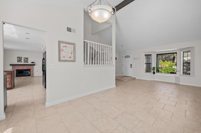 1161 Senwood Way, Fallbrook, CA 92028 - unfurnished living room featuring high vaulted ceiling, a fireplace, and a chandelier