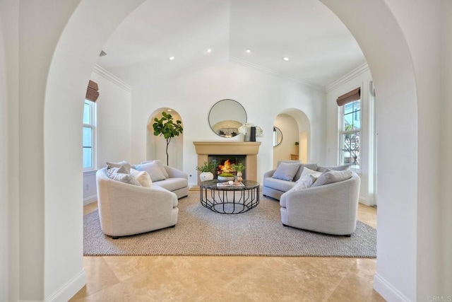 14317 Salida Del Sol, San Diego, CA 92127 - living room with arched walkways, a warm lit fireplace, ornamental molding, and lofted ceiling