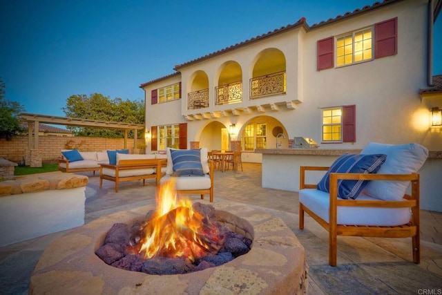 14317 Salida Del Sol, San Diego, CA 92127 - back of property featuring an outdoor living space with a fire pit, a patio area, a balcony, and stucco siding