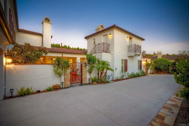 14317 Salida Del Sol, San Diego, CA 92127 - mediterranean / spanish home with a balcony, stucco siding, a tiled roof, and a gate