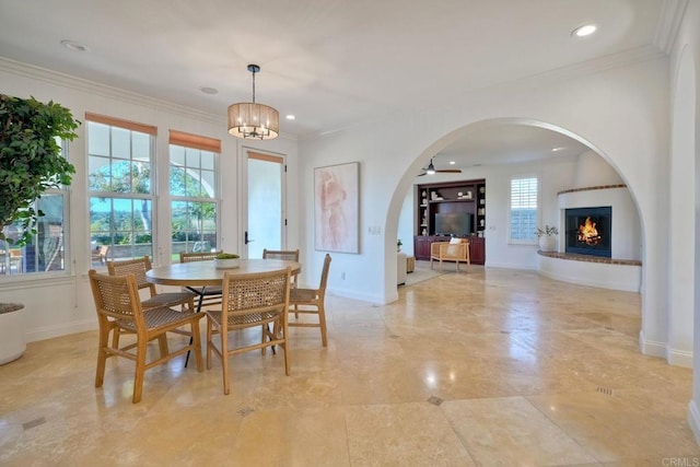 14317 Salida Del Sol, San Diego, CA 92127 - dining space featuring arched walkways, a lit fireplace, crown molding, recessed lighting, and a ceiling fan
