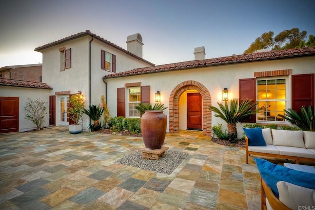 14317 Salida Del Sol, San Diego, CA 92127 - mediterranean / spanish-style home with a patio, a chimney, an outdoor living space, and stucco siding