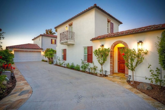 14317 Salida Del Sol, San Diego, CA 92127 - mediterranean / spanish-style house featuring a balcony, stucco siding, concrete driveway, a tiled roof, and a garage