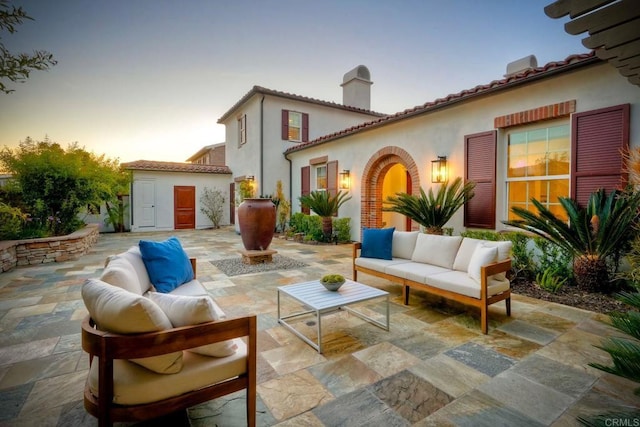 14317 Salida Del Sol, San Diego, CA 92127 - patio terrace at dusk featuring an outdoor living space, a patio area, and an outbuilding