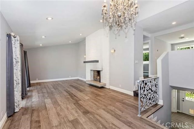 2350 Oak Park Rd, Glendora, CA 91741 - unfurnished living room featuring healthy amount of natural light, wood finished floors, a fireplace, recessed lighting, and a chandelier