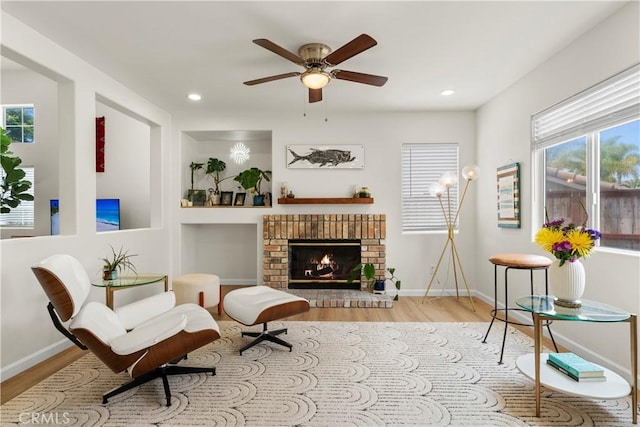 401 Lupine Way, Oceanside, CA 92057 - living area featuring wood finished floors, ceiling fan, a brick fireplace, and recessed lighting