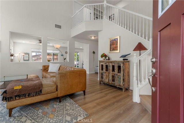 401 Lupine Way, Oceanside, CA 92057 - living room featuring stairs, a ceiling fan, wood finished floors, and a high ceiling