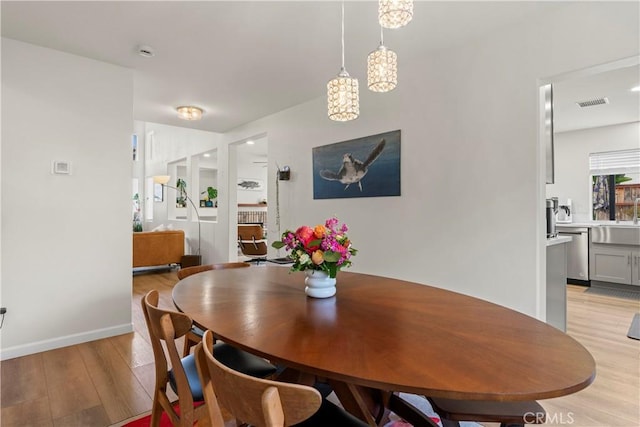 401 Lupine Way, Oceanside, CA 92057 - dining room with light wood-style flooring and a chandelier