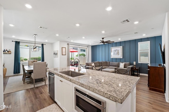 1979 Tangelo Way, Santa Paula, CA 93060 - kitchen featuring white cabinetry, appliances with stainless steel finishes, wood finished floors, an island with sink, and recessed lighting