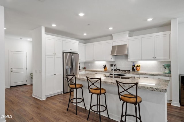1979 Tangelo Way, Santa Paula, CA 93060 - kitchen featuring stainless steel fridge with ice dispenser, range hood, a kitchen breakfast bar, white cabinets, and recessed lighting