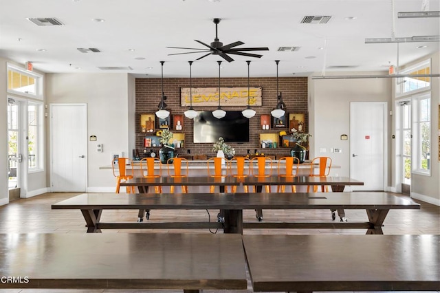 1979 Tangelo Way, Santa Paula, CA 93060 - dining room featuring plenty of natural light, a ceiling fan, brick wall, a towering ceiling, and wood finished floors