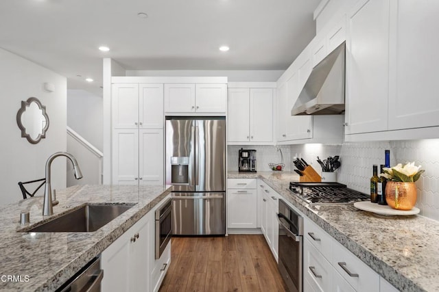 1979 Tangelo Way, Santa Paula, CA 93060 - kitchen featuring appliances with stainless steel finishes, range hood, wood finished floors, white cabinetry, and recessed lighting