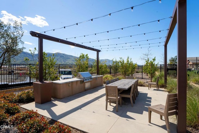 1979 Tangelo Way, Santa Paula, CA 93060 - fenced backyard with an outdoor kitchen, a patio, a mountain view, and outdoor dining space