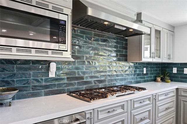 1579 Via Parque, Thousand Oaks, CA 91360 - kitchen featuring stainless steel appliances, wall chimney range hood, light countertops, and backsplash