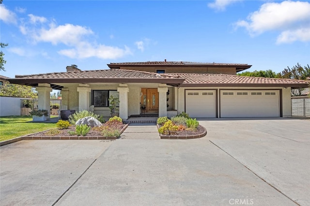 1579 Via Parque, Thousand Oaks, CA 91360 - mediterranean / spanish house with a tiled roof, a chimney, a garage, concrete driveway, and stucco siding