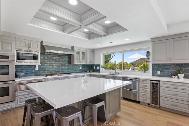 1579 Via Parque, Thousand Oaks, CA 91360 - kitchen with appliances with stainless steel finishes, wine cooler, wall chimney range hood, a warming drawer, and a kitchen breakfast bar