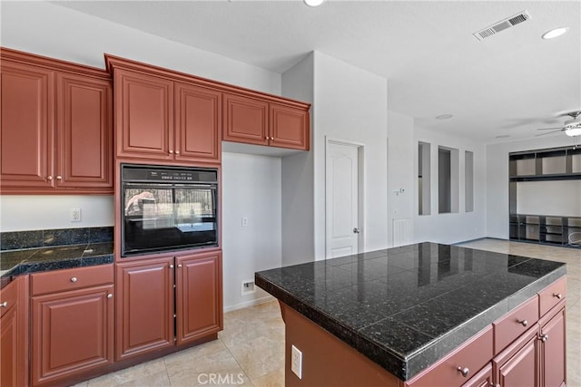 32522 Safflower St, Winchester, CA 92596 - kitchen with black oven, tile countertops, a ceiling fan, recessed lighting, and a center island