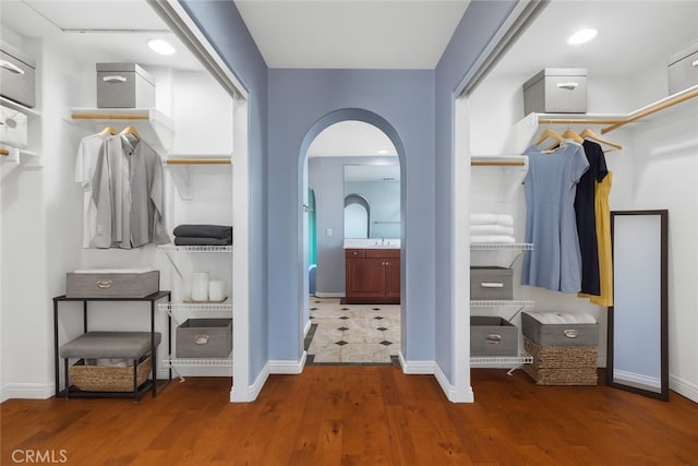 32522 Safflower St, Winchester, CA 92596 - spacious closet featuring wood finished floors and arched walkways
