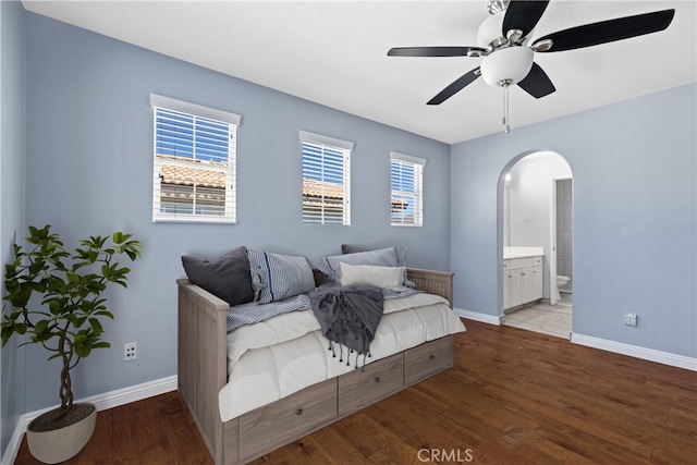 32522 Safflower St, Winchester, CA 92596 - bedroom with arched walkways, wood finished floors, ensuite bath, and a ceiling fan