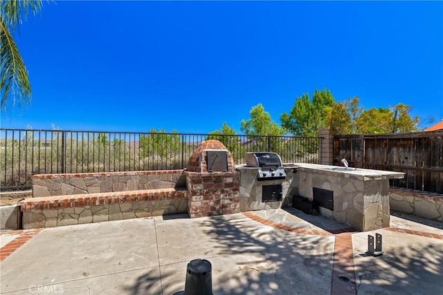 32522 Safflower St, Winchester, CA 92596 - fenced backyard featuring exterior kitchen and a patio area