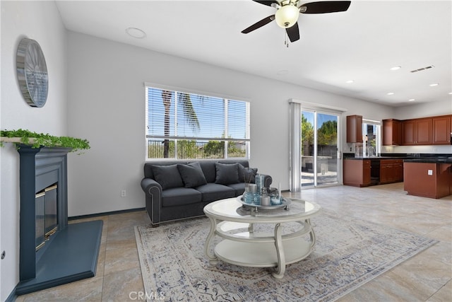 32522 Safflower St, Winchester, CA 92596 - living area with ceiling fan, recessed lighting, a glass covered fireplace, and light tile patterned flooring