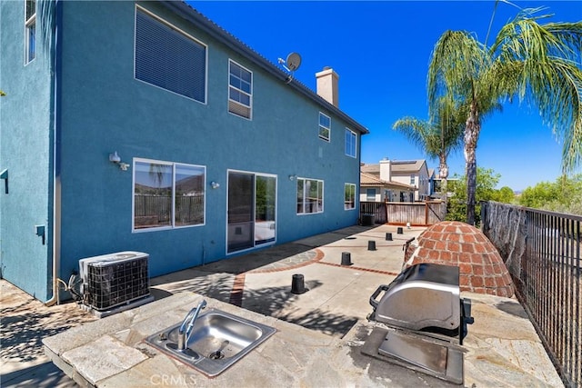 32522 Safflower St, Winchester, CA 92596 - rear view of property with a chimney, a patio, stucco siding, and area for grilling