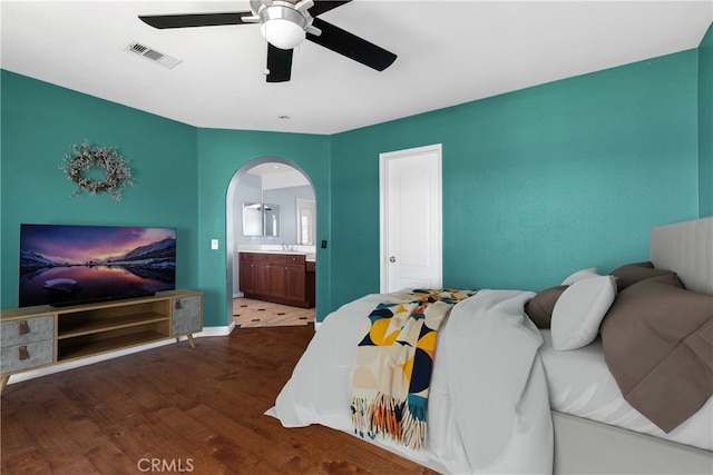 32522 Safflower St, Winchester, CA 92596 - bedroom featuring wood finished floors, arched walkways, connected bathroom, and ceiling fan