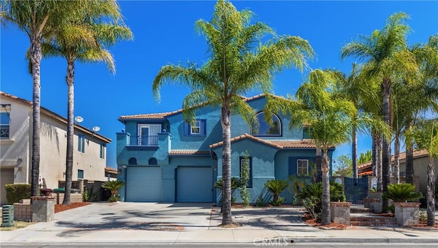 32522 Safflower St, Winchester, CA 92596 - mediterranean / spanish-style home featuring a balcony, stucco siding, a garage, a tile roof, and concrete driveway