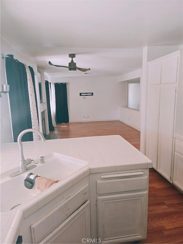 38644 Palms Pl, Palmdale, CA 93552 - kitchen with tile countertops, ceiling fan, and dark wood-style flooring