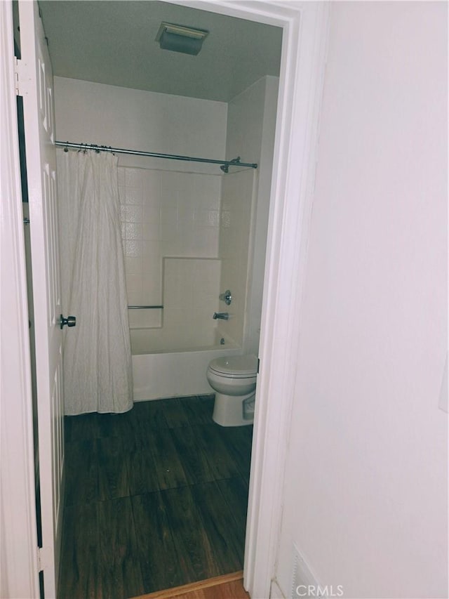 38644 Palms Pl, Palmdale, CA 93552 - bathroom featuring wood finished floors and shower / bath combo with shower curtain