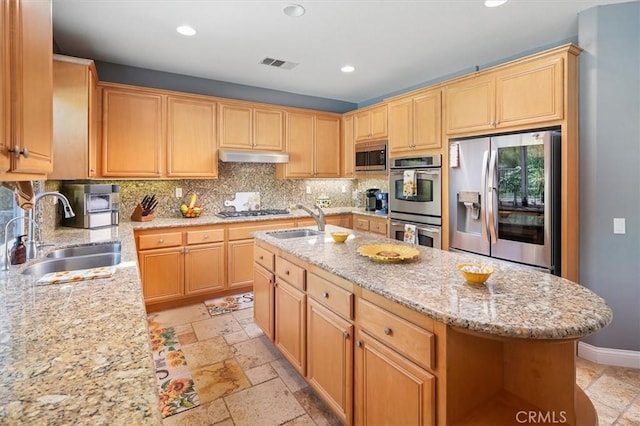 29160 Harmony Way, Saugus, CA 91390 - kitchen featuring appliances with stainless steel finishes, stone tile floors, tasteful backsplash, recessed lighting, and under cabinet range hood
