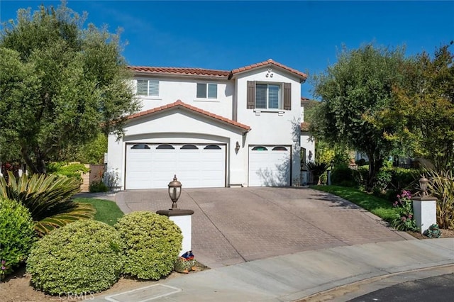 29160 Harmony Way, Saugus, CA 91390 - mediterranean / spanish home with an attached garage, a tile roof, stucco siding, and decorative driveway