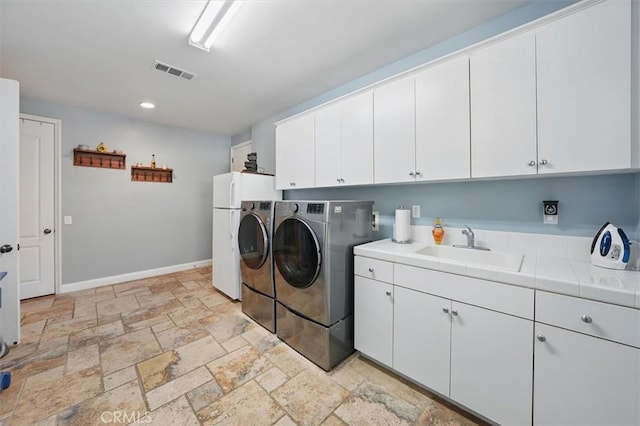 29160 Harmony Way, Saugus, CA 91390 - washroom with cabinet space, washing machine and dryer, stone tile floors, and recessed lighting